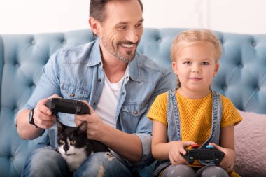 Güzel neşeli baba ve kız video oyunları oynarken