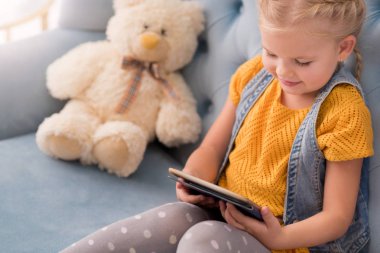 Sevimli küçük kız bir tablet holding