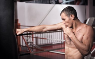 Adam yumruk torbası spor salonunda boks