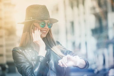 Smiling young woman talking on cell phone