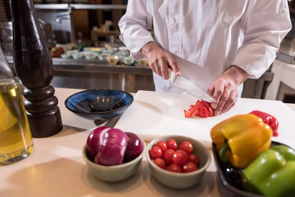 Strong hands of the chef cutting paper in the kitchen — Stock Photo, Image