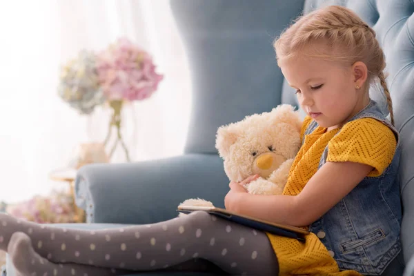 Pleasant cute girl looking at the tablet — Stock Photo, Image