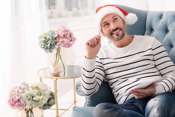 Feliz hombre positivo escribiendo una lista de regalos — Foto de Stock