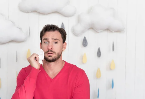 Unhappy ill man standing against cloudy background — Stock Photo, Image