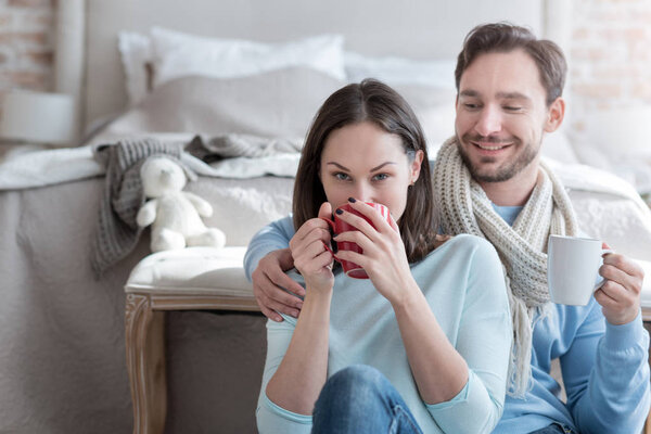 Good looking nice woman taking a sip of tea