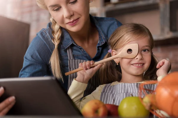 Joyful girl having fun with her mother in the kitchen — Stock Photo, Image