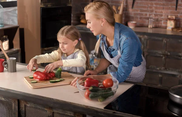 Pacifica madre cariñosa cocinando con su hija en la cocina —  Fotos de Stock