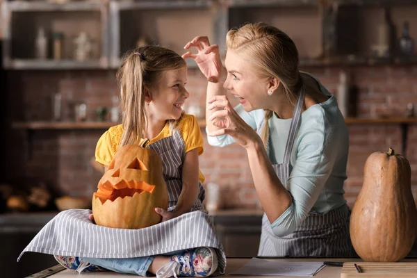 Joyful mother acting the ape with her little daughter — Stock Photo, Image