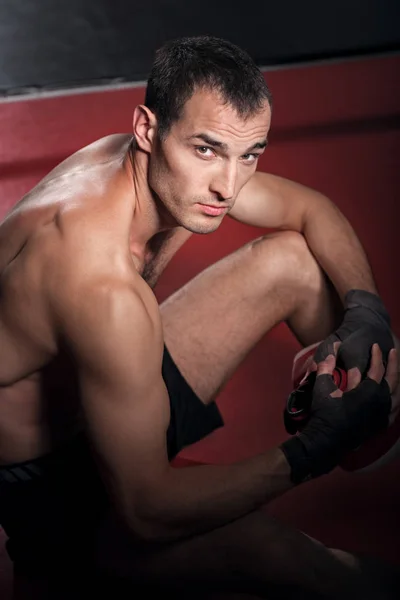 Top view of handsome sportsman sitting on floor — Stock Photo, Image