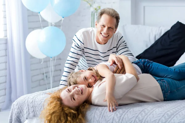 Delighted little girl having fun with her grandparents — Stock Photo, Image