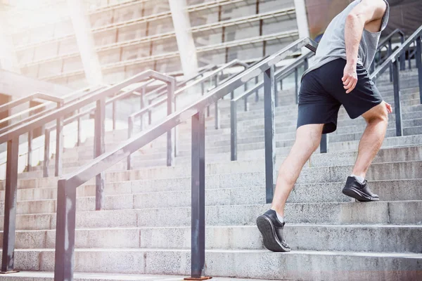 Uomo attivo che sale le scale in abbigliamento sportivo — Foto Stock