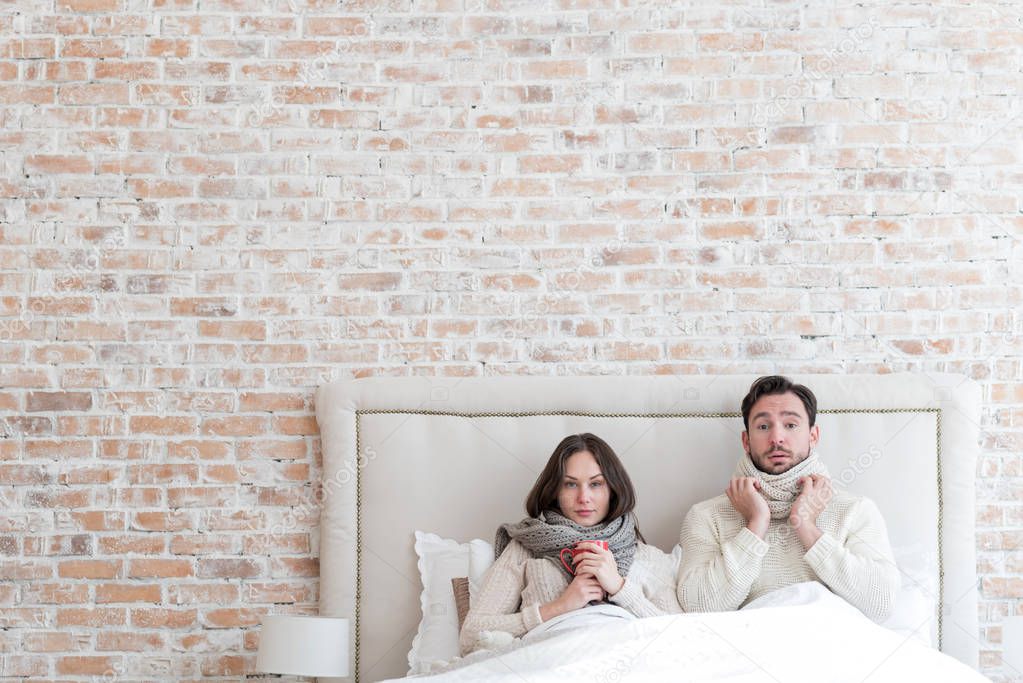 Cheerless depressed couple suffering from influenza together