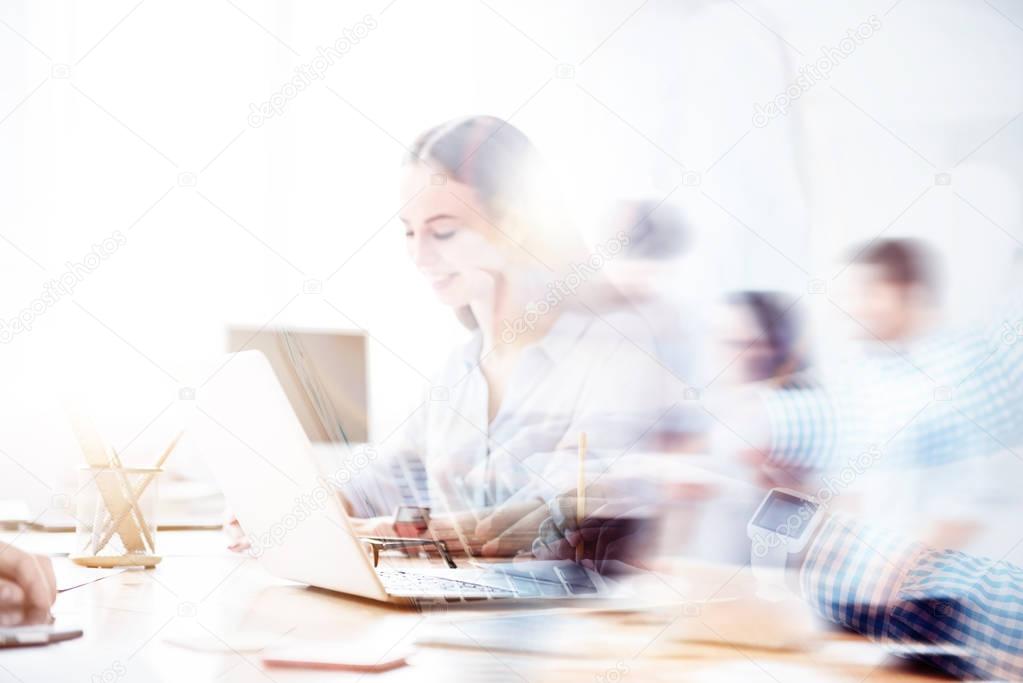 Double exposure of nice smiling girl working on laptop