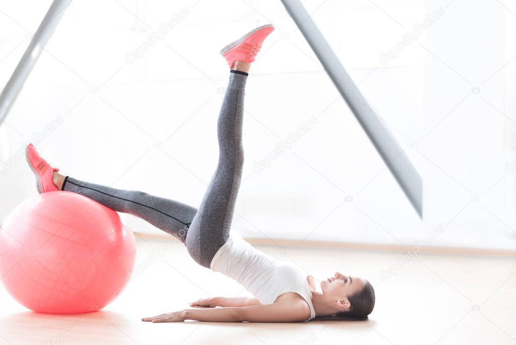 Active slim woman holding her leg up
