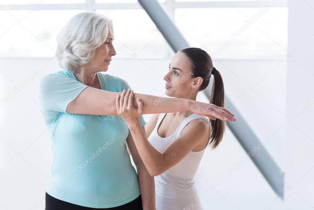 Experienced fitness coach working out with a client