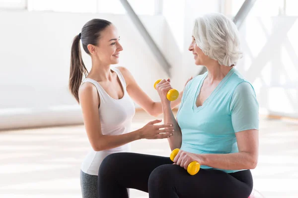Delighted fitness coach looking at the woman — Stock Photo, Image