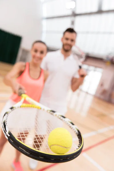 Selective focus of tennis ball lying on the racket Stock Photo