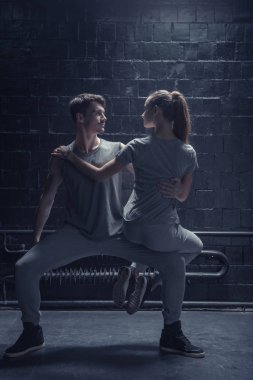 İnce dansçılar karanlık ışıklı odaya gerçekleştirme