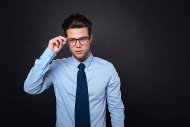 Hoş emin businessmna ayakta gisolated siyah arka plan üzerine