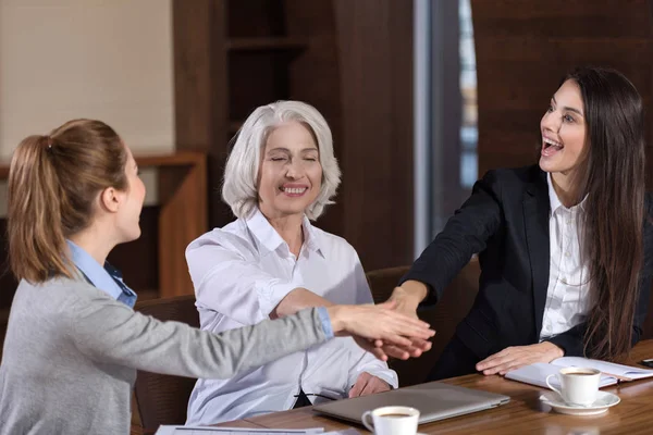 Delighted colleagues holding each others hands — Stock Photo, Image