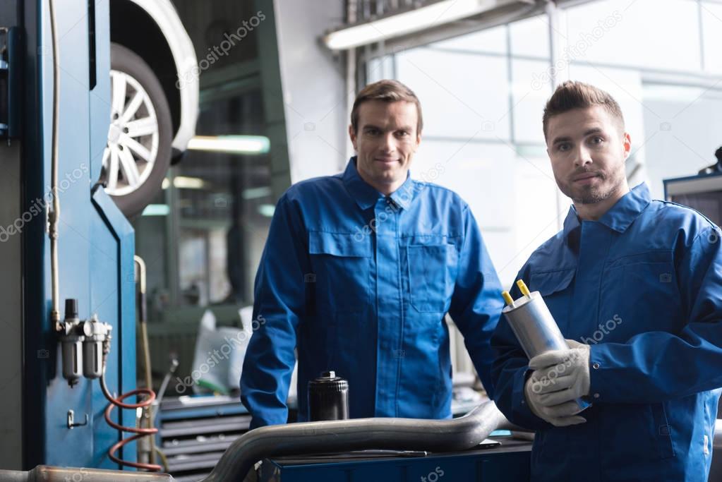 Professional mechanics working in auto service