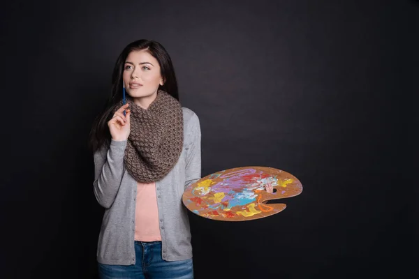 Delighted content female artist thinking — Stock Photo, Image