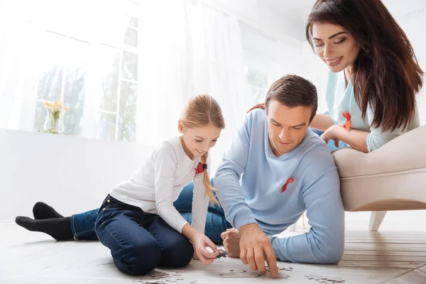 Piacevole premuroso padre che fa con sua figlia un puzzle — Foto Stock