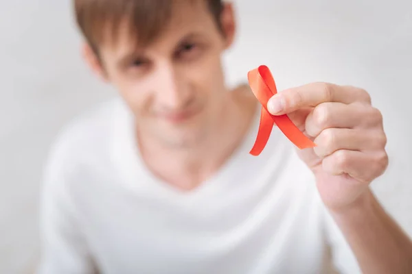 Selective focus of the red AIDS ribbon — Stock Photo, Image