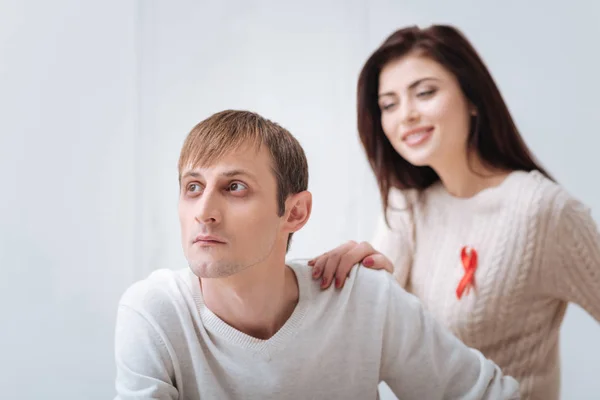 Pleasant thoughtful man sitting near his girlfriend — Stock Photo, Image