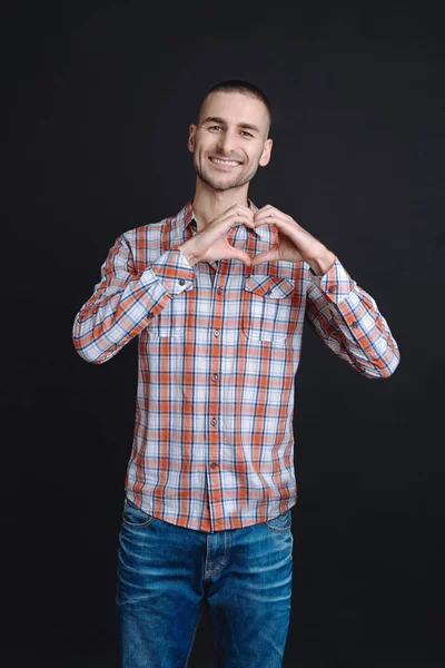 Positive delighted man showing heart — Stock Photo, Image