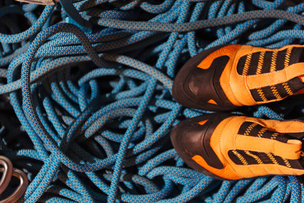 Close up of climbing boots standing on insurance ropes