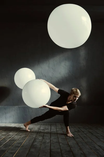 Potente ballerino che si esibisce davanti alla parete scura — Foto Stock