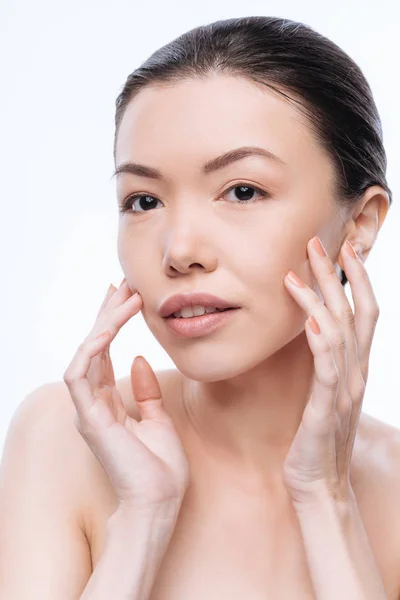 Involved young Mongolian woman touching her healthy skin — Stock Photo, Image