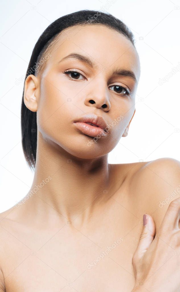 Charming young Negroid woman expressing elegance in the studio