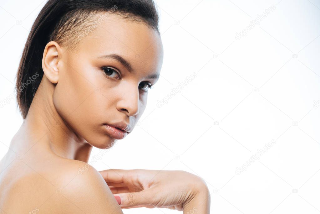 Graceful young Negroid woman posing in the studio