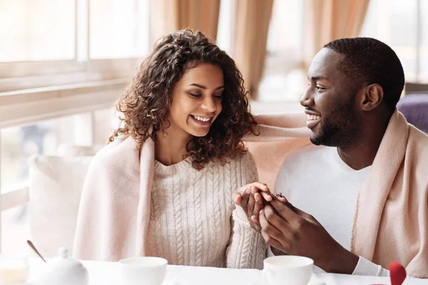 Cheerful young African American couple getting engaged in the caf — Stock Photo, Image