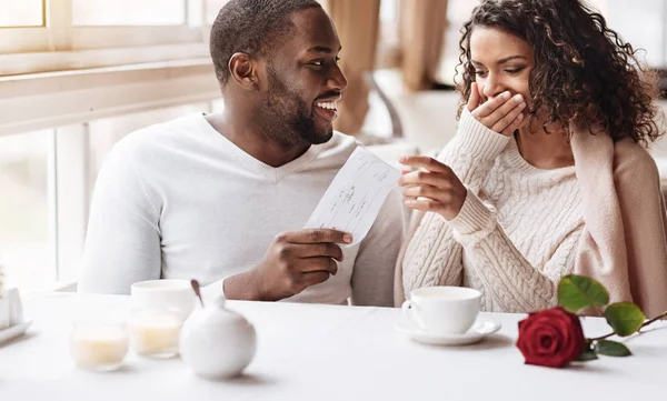 Delighted African American woman receiving a present from her boyfriend — Stock Photo, Image