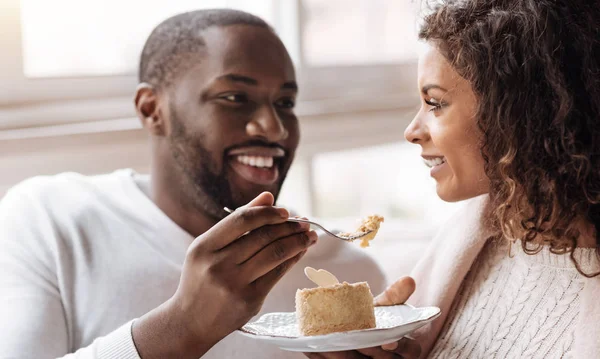 Funny African American couple enjoying the dessert in the cafe — Stock Photo, Image