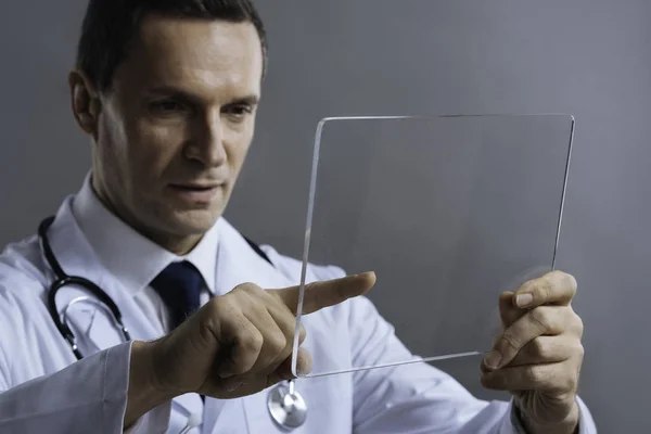 Concentrated doctor using special glass — Stock Photo, Image