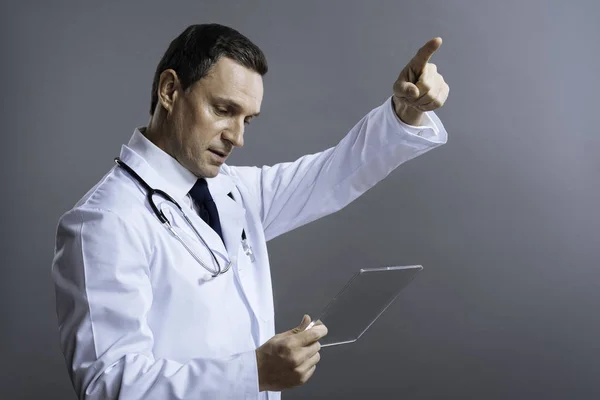 Handsome doctor gesturing with medical glass — Stock Photo, Image