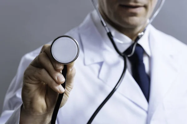 Close up of smart doctor holding stethoscope — Stock Photo, Image