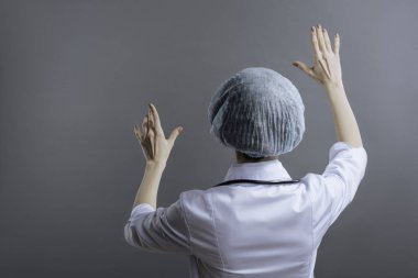 Kadın doktor yüzü ile ayakta duvara döndü