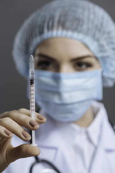 Close up of young doctor using hypodermic needle — Stock Photo, Image