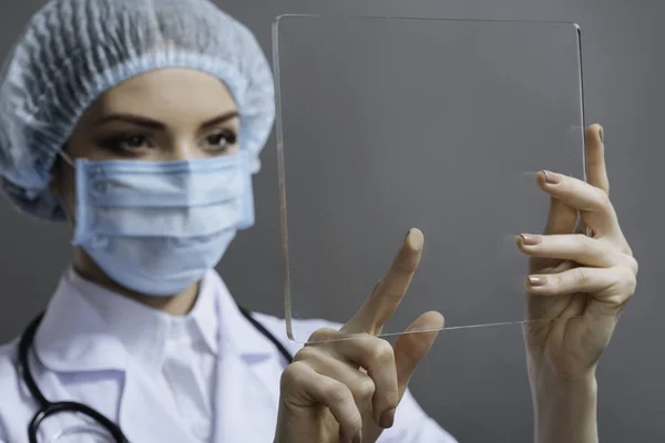 Female doctor touching special medical glass — Stock Photo, Image