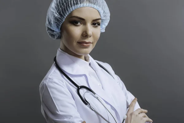 Deliziato medico femminile in posa su sfondo grigio — Foto Stock