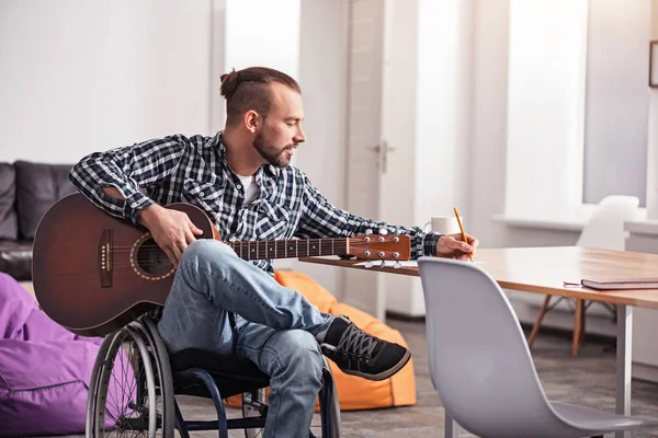 Handicapped creative man writing down new song — Stock Photo, Image