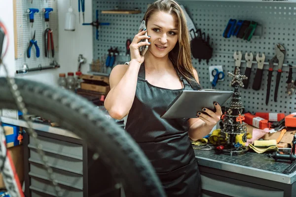 Gülümseyen genç craftswoman onarımları araçları kullanma
