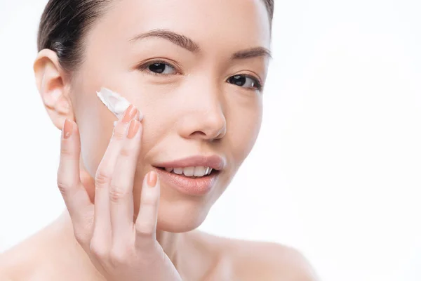 Pretty joyful woman using facial cream — Stock Photo, Image