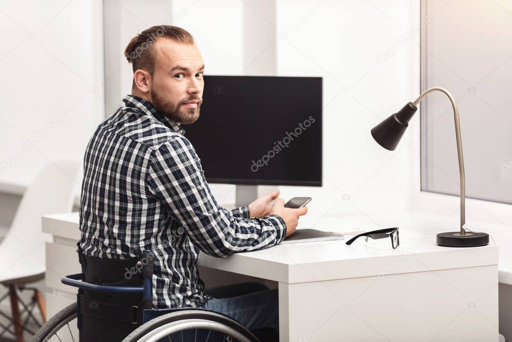 Young physically challenged person working in home office