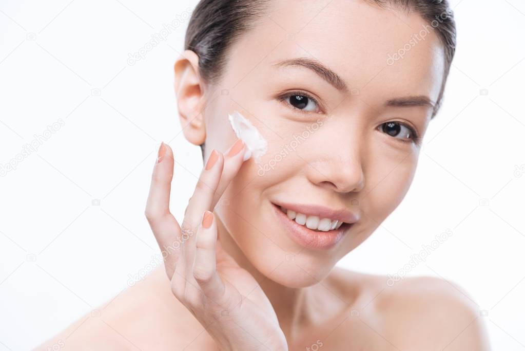 Positive charming woman caring about her face